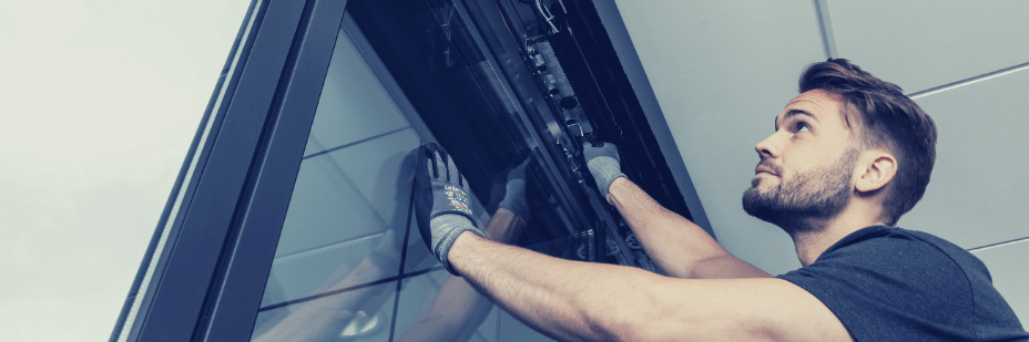 Un technicien s’apprête a réparer une porte automatique